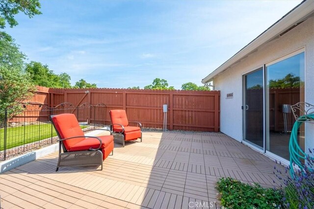 wooden deck featuring a fenced backyard