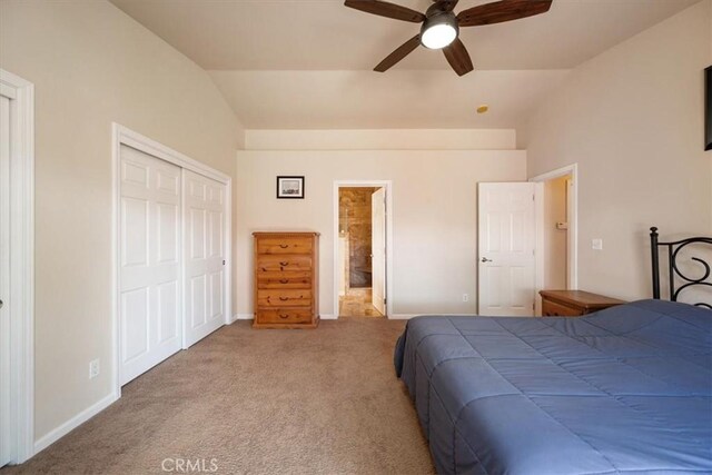 bedroom featuring carpet floors, baseboards, lofted ceiling, and a closet
