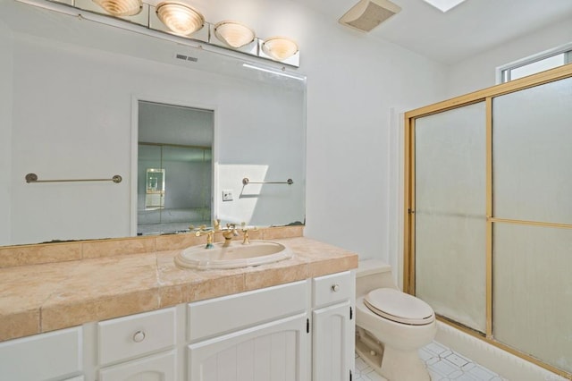 full bath featuring tile patterned flooring, vanity, toilet, visible vents, and a stall shower