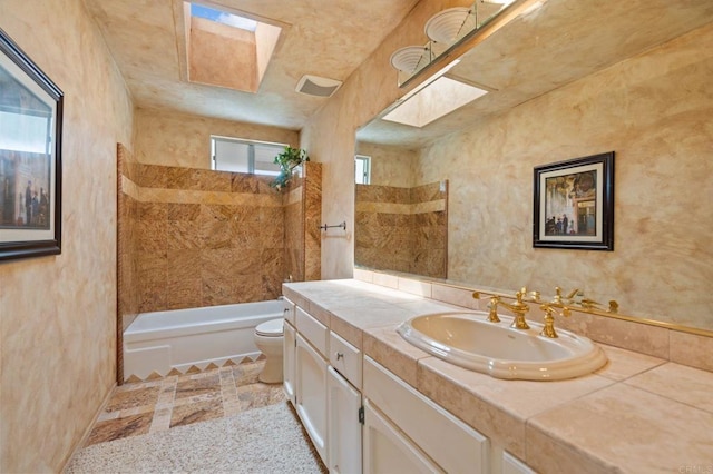 bathroom featuring vanity, washtub / shower combination, and toilet