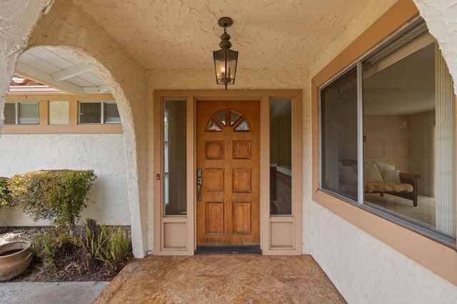 property entrance with stucco siding