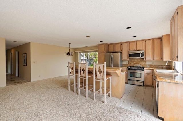 kitchen with light countertops, a sink, light carpet, and stainless steel appliances