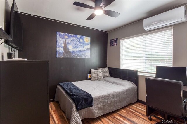 12022 W Redbank St, Sun Valley, CA 91352 - bedroom with an AC wall unit, wood finished floors, and ceiling fan
