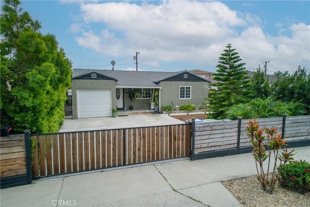 12022 W Redbank St, Sun Valley, CA 91352 - ranch-style home with a garage, a fenced front yard, stucco siding, and driveway