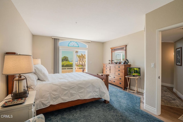 1130 Mandalay Beach Rd, Oxnard, CA 93035 - bedroom with baseboards, access to exterior, and wood finished floors