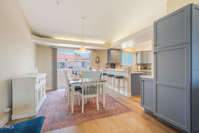 1130 Mandalay Beach Rd, Oxnard, CA 93035 - dining room featuring baseboards, plenty of natural light, and light wood-type flooring
