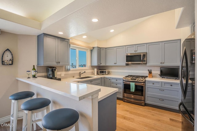 1130 Mandalay Beach Rd, Oxnard, CA 93035 - kitchen with gray cabinetry, appliances with stainless steel finishes, a peninsula, and a sink