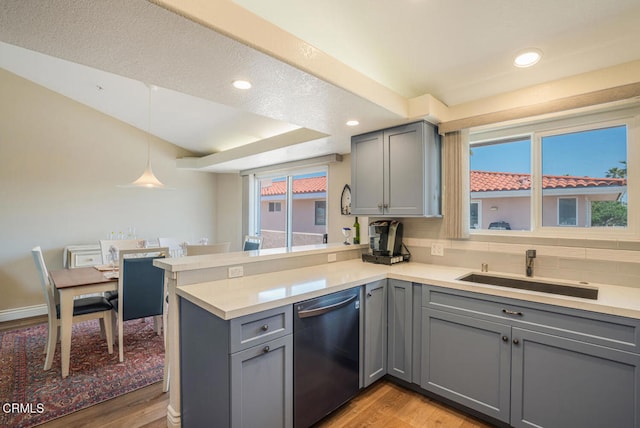 1130 Mandalay Beach Rd, Oxnard, CA 93035 - kitchen featuring a peninsula, a sink, light wood-style flooring, dishwasher, and gray cabinetry