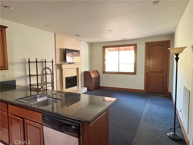 344 Triana Ln Unit 102, Avalon, CA 90704 - kitchen with dishwasher, a sink, open floor plan, a fireplace, and dark colored carpet