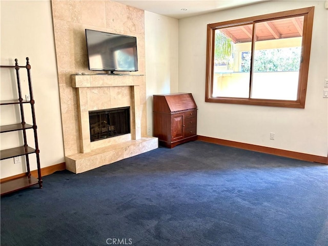 344 Triana Ln Unit 102, Avalon, CA 90704 - unfurnished living room with dark colored carpet, baseboards, and a premium fireplace