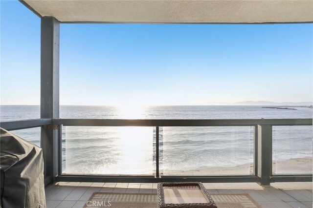 balcony featuring a water view