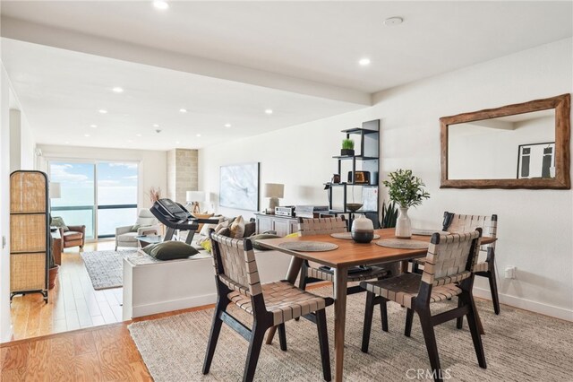 dining room featuring baseboards, recessed lighting, and light wood-style flooring