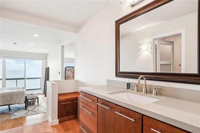 bathroom featuring vanity, recessed lighting, and wood finished floors