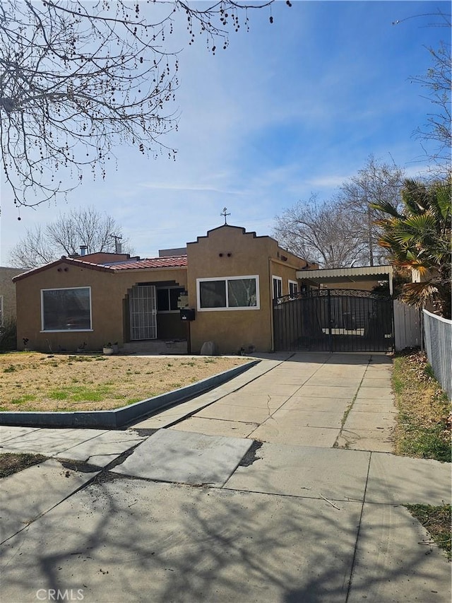 44645 Fig Ave, Lancaster, CA 93534 - view of front of house featuring concrete driveway, fence, a gate, and stucco siding