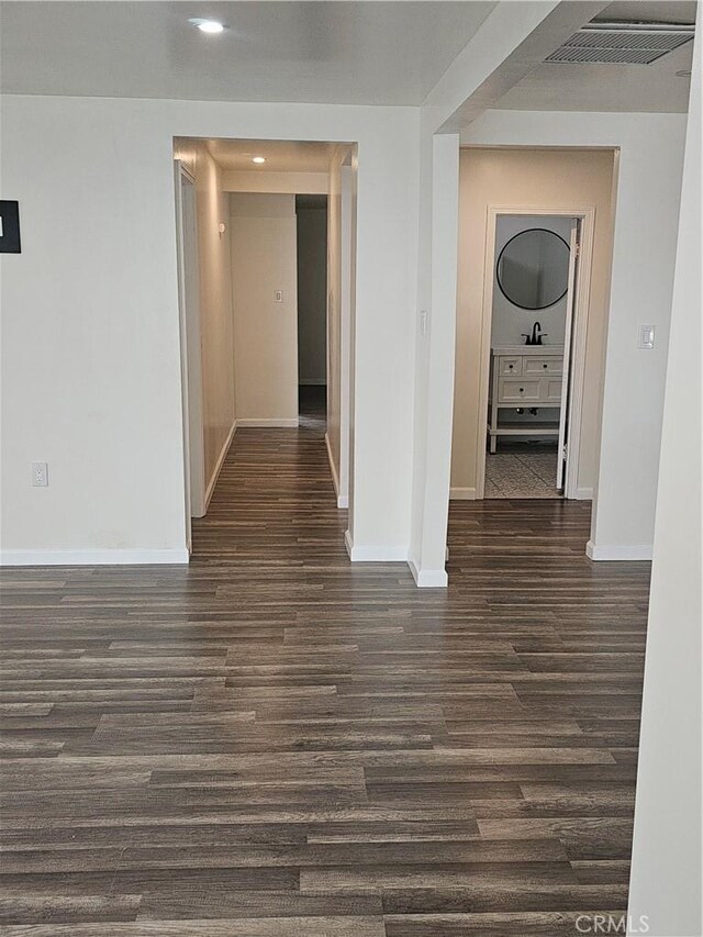 44645 Fig Ave, Lancaster, CA 93534 - hall featuring a sink, recessed lighting, baseboards, dark wood-type flooring, and visible vents