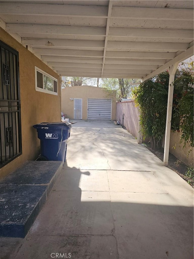 44645 Fig Ave, Lancaster, CA 93534 - view of patio with fence, an outbuilding, and a carport