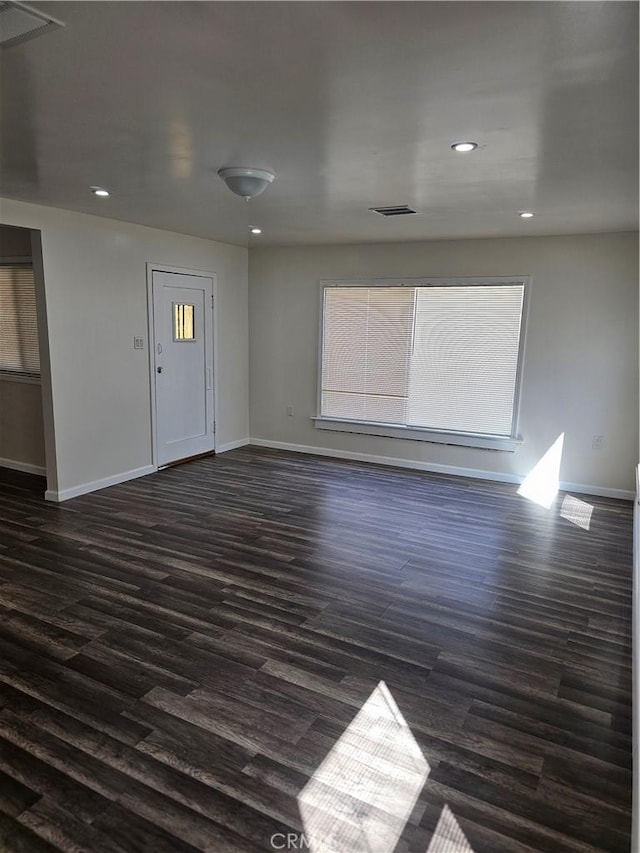 44645 Fig Ave, Lancaster, CA 93534 - empty room with baseboards, dark wood-type flooring, recessed lighting, and visible vents