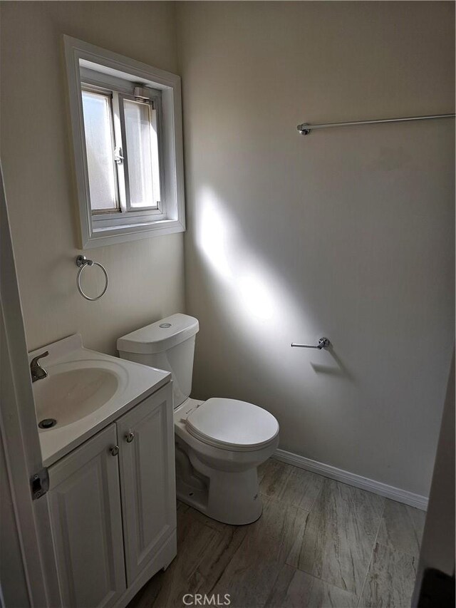 44645 Fig Ave, Lancaster, CA 93534 - bathroom with toilet, wood finished floors, and vanity