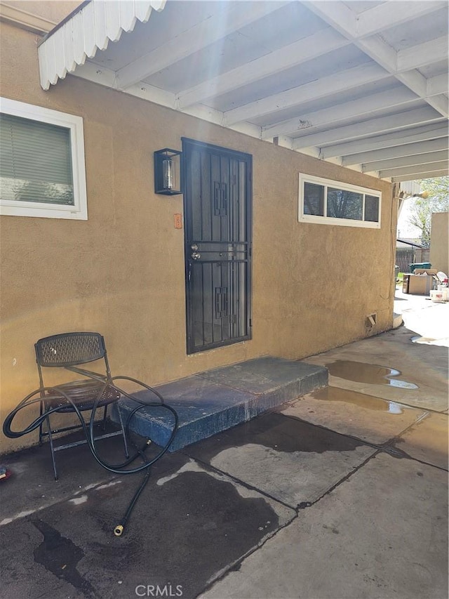 44645 Fig Ave, Lancaster, CA 93534 - property entrance featuring a patio area and stucco siding