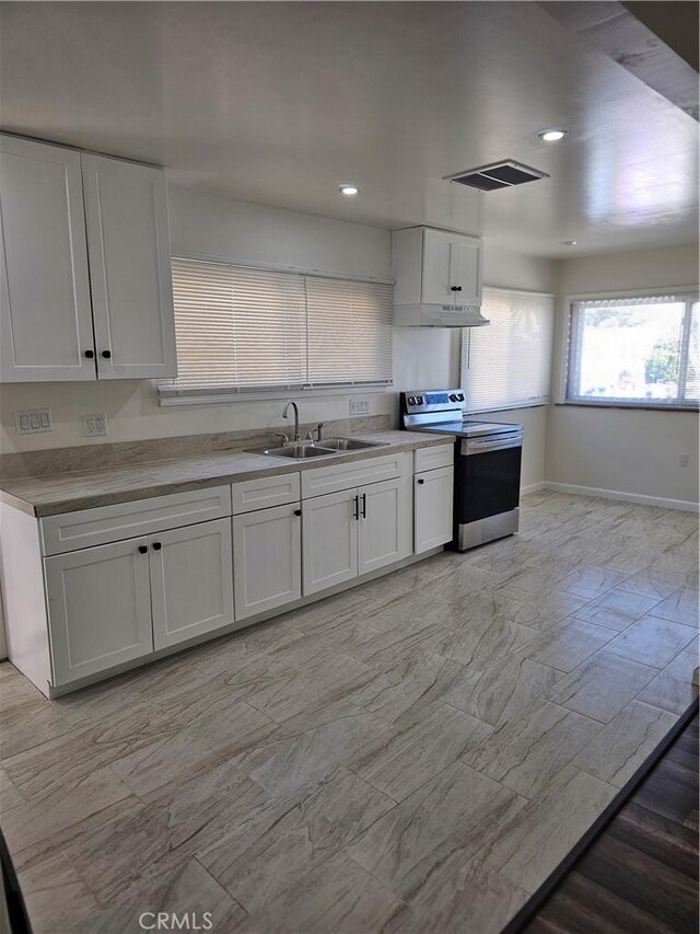 44645 Fig Ave, Lancaster, CA 93534 - kitchen featuring stainless steel electric range oven, white cabinets, visible vents, and a sink
