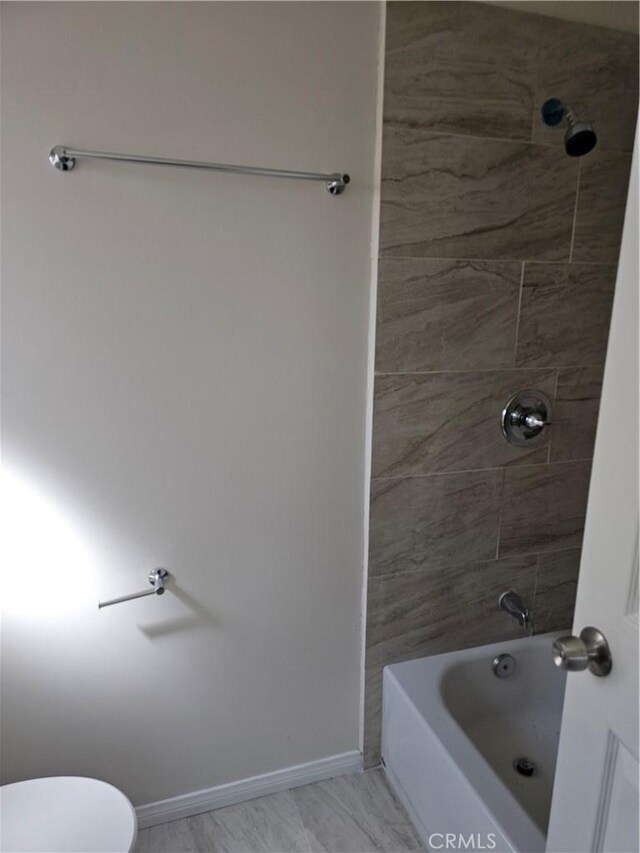 44645 Fig Ave, Lancaster, CA 93534 - full bathroom featuring toilet, baseboards, and shower / bathing tub combination