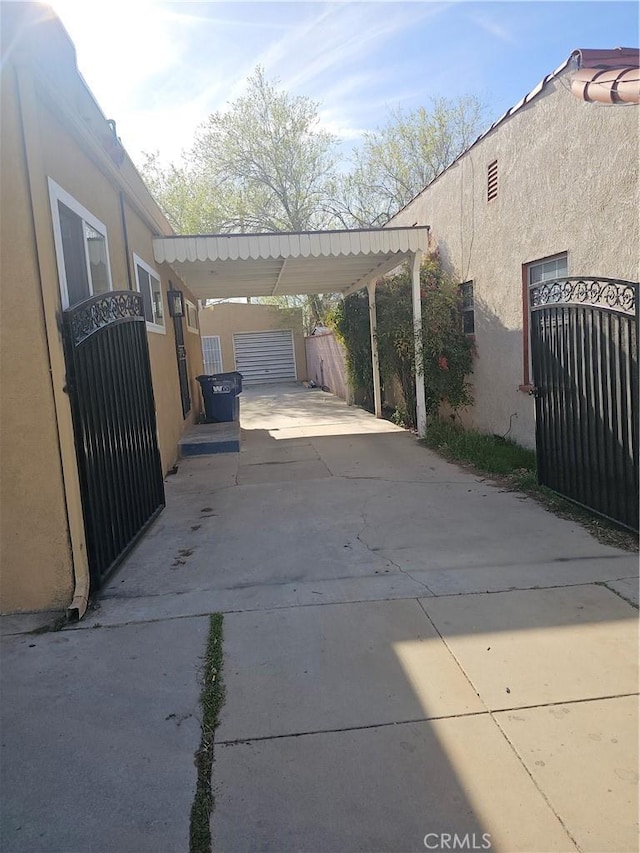 44645 Fig Ave, Lancaster, CA 93534 - view of parking featuring a gate, fence, driveway, and an attached carport