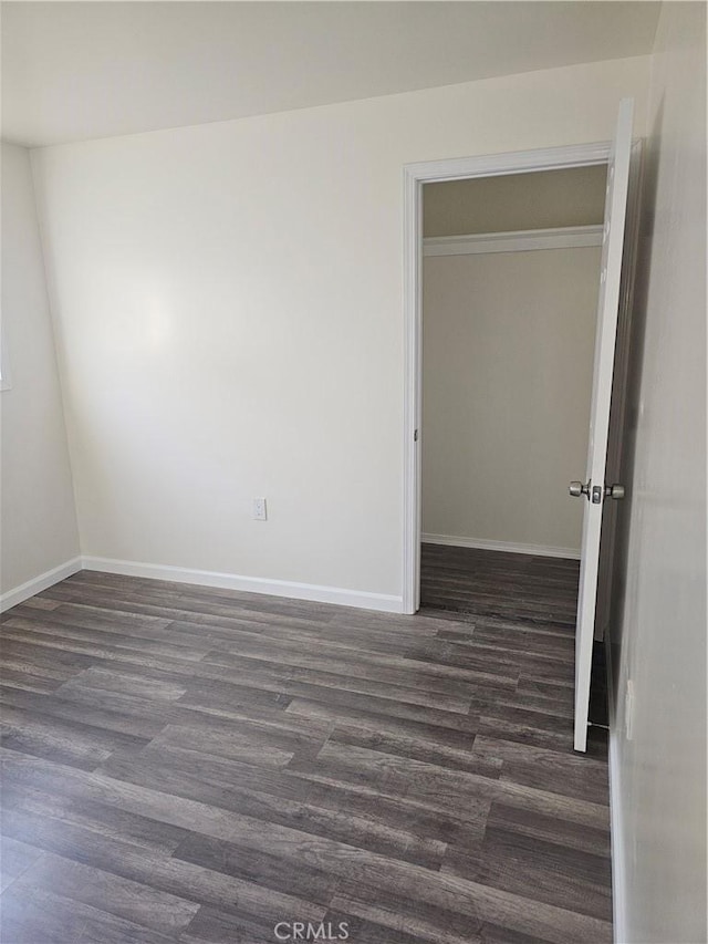 44645 Fig Ave, Lancaster, CA 93534 - unfurnished room featuring baseboards and dark wood-type flooring