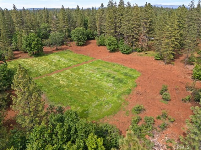 birds eye view of property with a wooded view