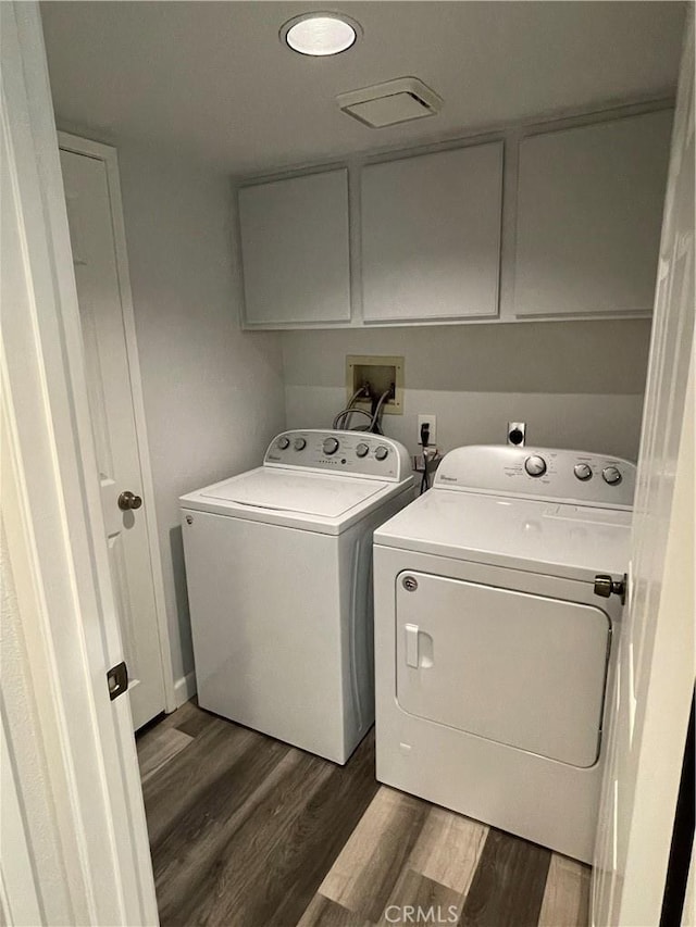 33741 Edgewater Dr Unit 164, Dana Point, CA 92629 - washroom featuring cabinet space, washing machine and dryer, and dark wood-style flooring