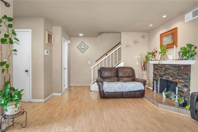 1925 Glenoaks Blvd, Unit San Fernando, CA 91340 - living area with light wood-type flooring, stairway, a fireplace with raised hearth, recessed lighting, and baseboards
