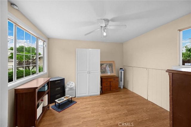 interior space with a ceiling fan, plenty of natural light, and light wood-style flooring