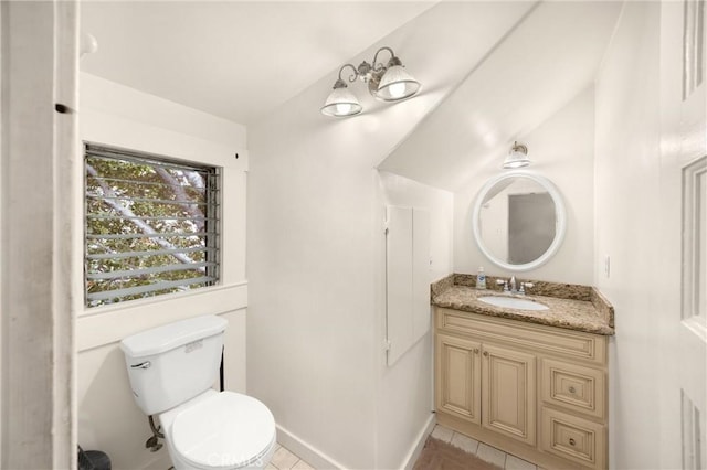 bathroom with toilet, tile patterned floors, baseboards, and vanity