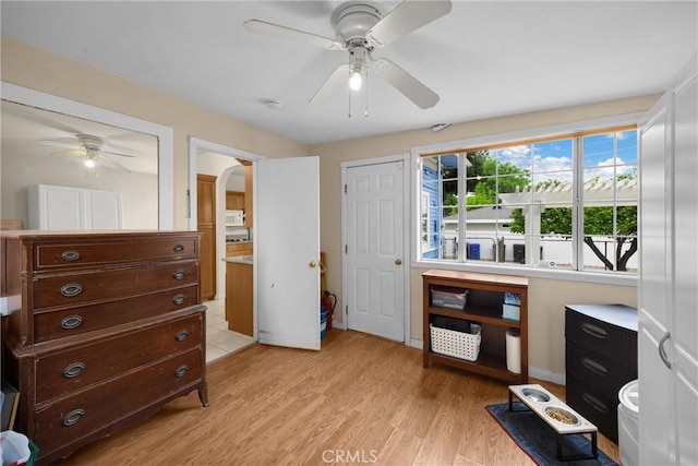interior space with light wood-style floors and ceiling fan