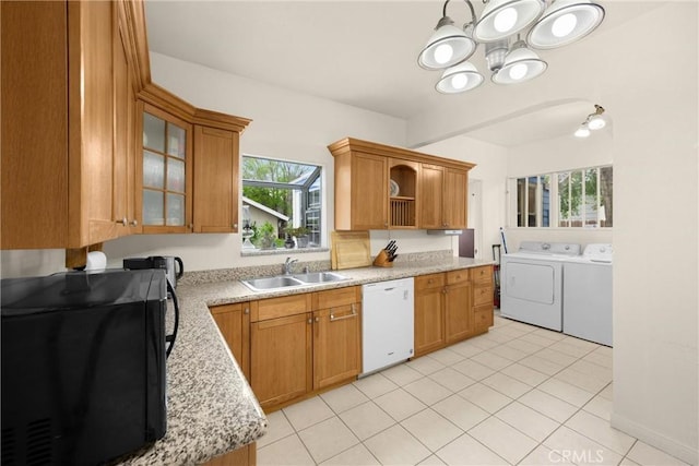 kitchen with independent washer and dryer, black microwave, a sink, dishwasher, and a chandelier