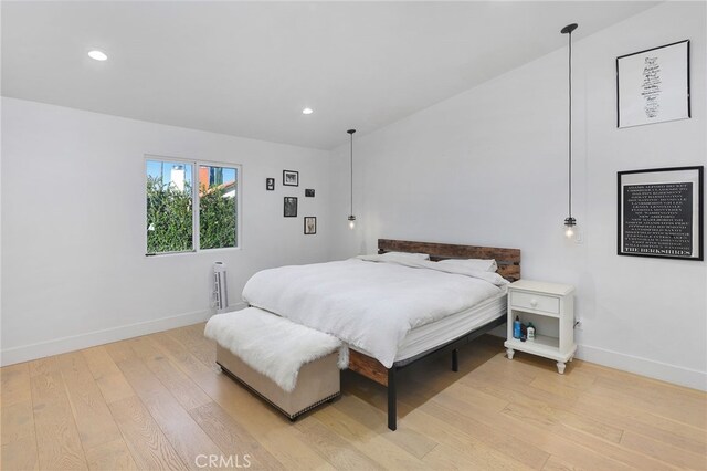 bedroom with baseboards, recessed lighting, and light wood-style flooring