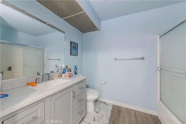full bath featuring vanity, toilet, and baseboards