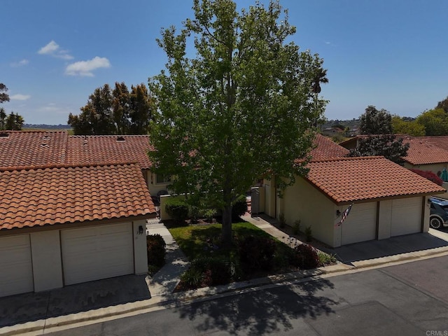 view of front of home with stucco siding and a tile roof
