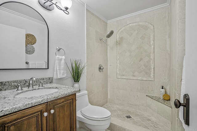 full bathroom featuring crown molding, vanity, a tile shower, and toilet