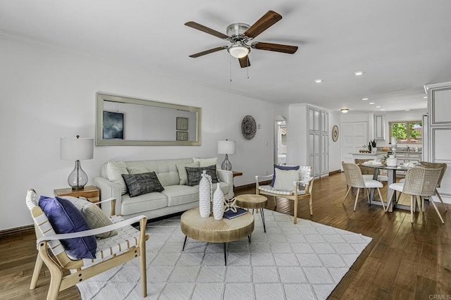 living area featuring recessed lighting, a ceiling fan, baseboards, and wood finished floors