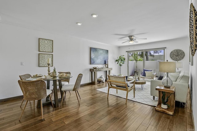 living room with ornamental molding, wood finished floors, baseboards, ceiling fan, and recessed lighting