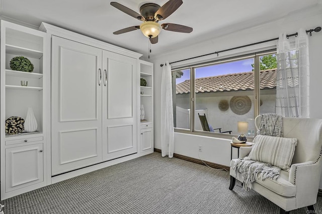 sitting room featuring a healthy amount of sunlight, baseboards, ceiling fan, and carpet flooring