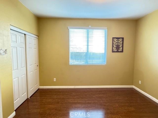 12271 Oldenberg Ct, Rancho Cucamonga, CA 91739 - unfurnished bedroom with wood finished floors, baseboards, and a closet