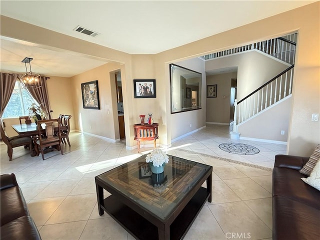 12271 Oldenberg Ct, Rancho Cucamonga, CA 91739 - living room featuring light tile patterned floors, baseboards, stairway, and a chandelier