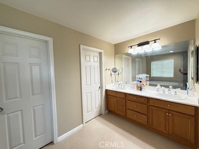 12271 Oldenberg Ct, Rancho Cucamonga, CA 91739 - bathroom with double vanity and baseboards