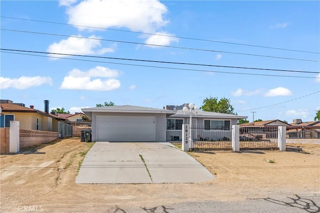 single story home with concrete driveway, an attached garage, a fenced front yard, and a gate