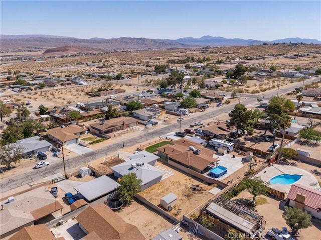 drone / aerial view with a residential view, a mountain view, and a desert view