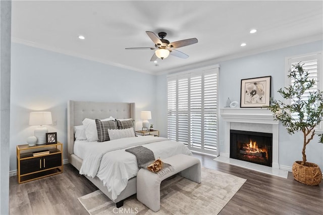 bedroom featuring ornamental molding, recessed lighting, and wood finished floors