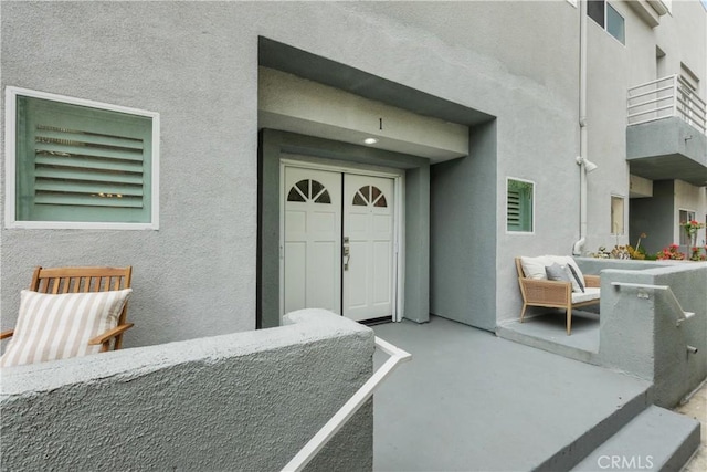 entrance to property with stucco siding