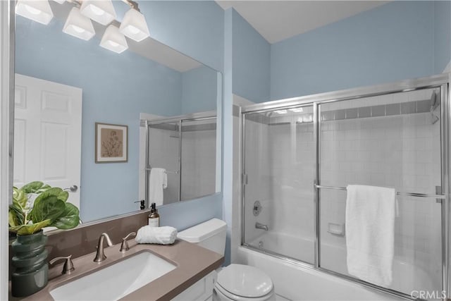 full bathroom with vanity, enclosed tub / shower combo, and toilet