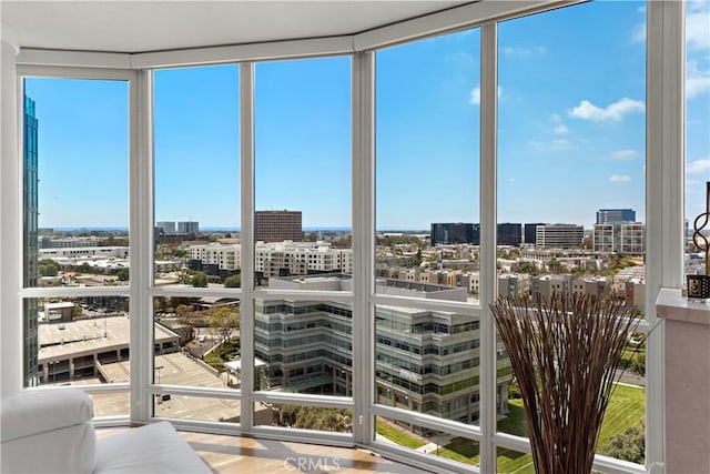 sunroom / solarium featuring a view of city and a healthy amount of sunlight